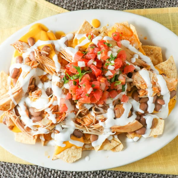 Taqueria Morena's chicken nachos with cheese, beans, sour cream, and pico de gallo.